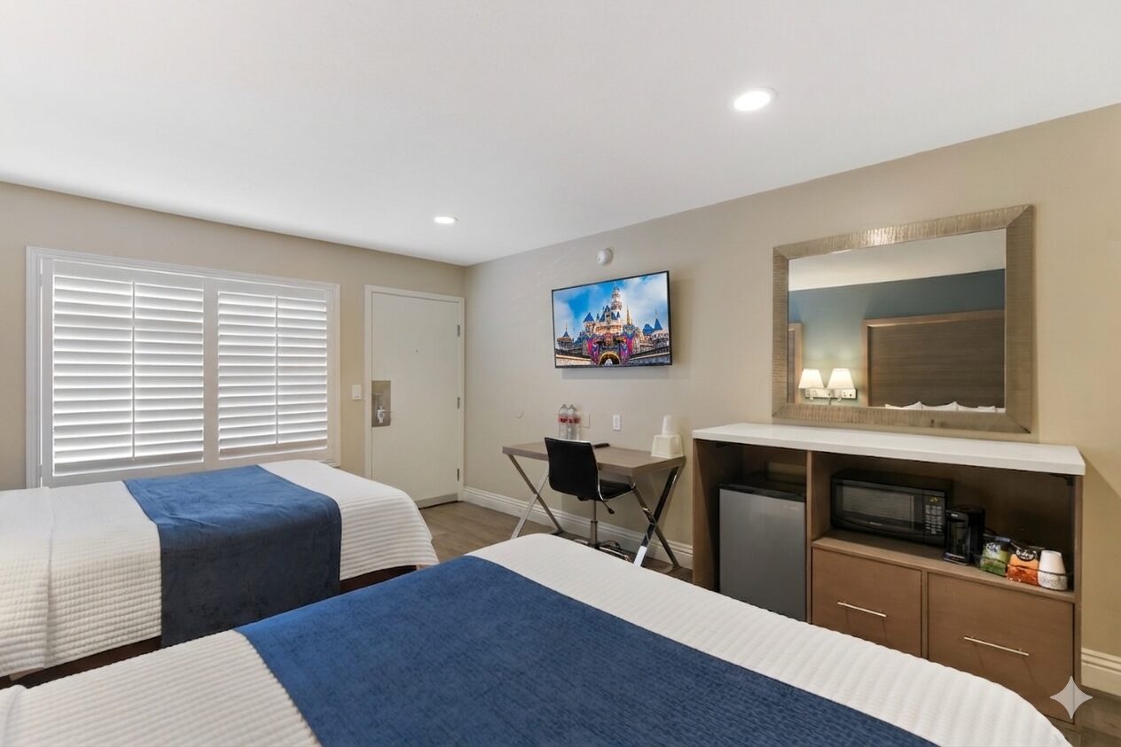 Hotel 414 Anaheim 2 Queen Beds with desk, chair, television, refrigerator, mirror.