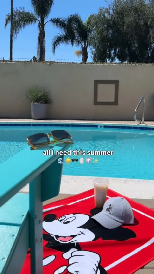 a pool with a red towel and a pair of sunglasses on it